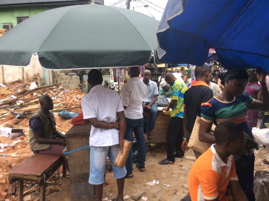 The shops that used to be within the building are now desks and umbrellas.